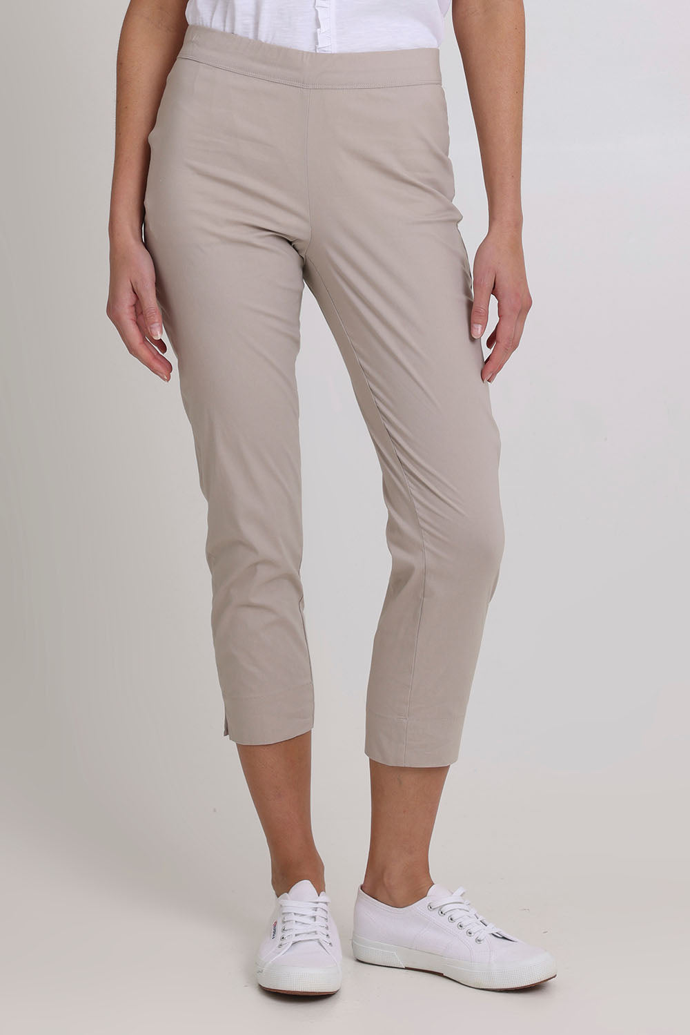 Model Madeline wearing size 10 of the Fuss Free 7/8 Pant in colour Sand, from the front, cropped image