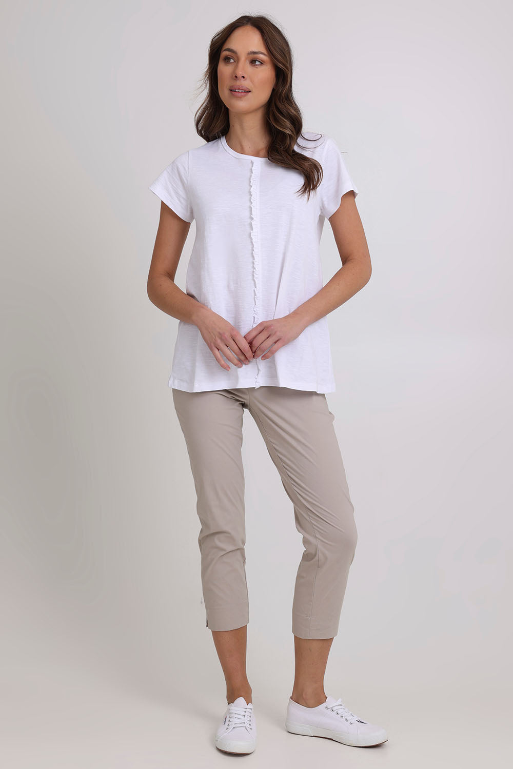 Model Madeline wearing size 10 of the Fuss Free 7/8 Pant in colour Sand, from the front, showing the whole outfit