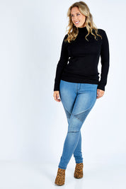 Model Jess wearing size L of the Pure Merino Rib Polo in colour Black (Black), from the front, showing the whole outfit