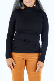 Model Nadine wearing size S of the Pure Merino Rib Polo in colour Black (Black), from the front, cropped image
