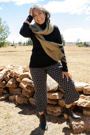 Model Nadine wearing size S of the Pure Merino Rib Polo in colour Black (Black), from the front, showing the whole outfit