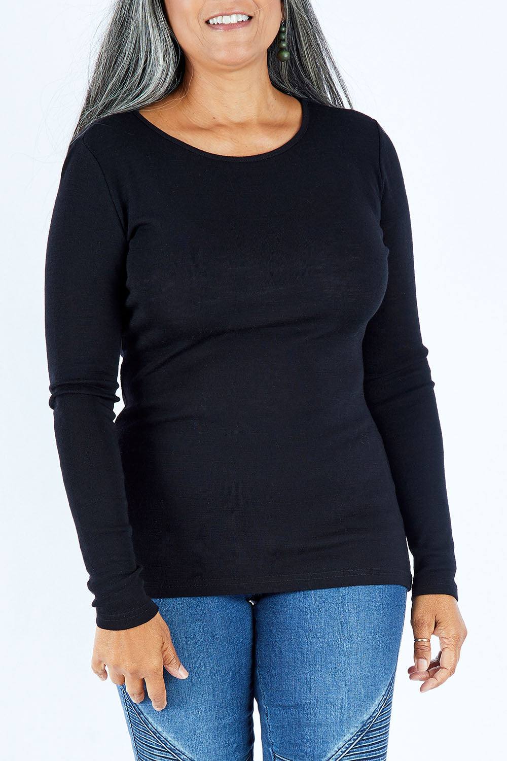 Model Nadine wearing size S of the Merino Signature Crew Top in colour Black (Black), from the front, cropped image
