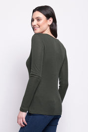 A model wearing the Merino Signature Crew Top in colour Moss (Green), from the back