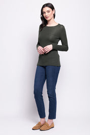 A model wearing the Merino Signature Crew Top in colour Moss (Green), from the front, showing the whole outfit