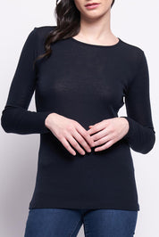 A model wearing the Merino Signature Crew Top in colour Truenavy (Blue), from the front, cropped image