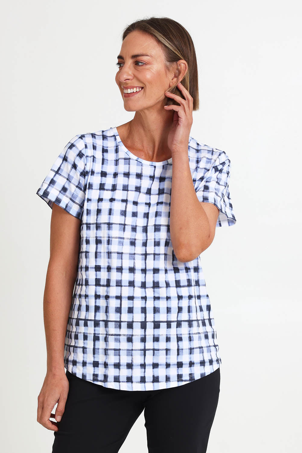 Model Riinar wearing size 10 of the Here Comes Summer Tee – Checkers in colour Checkers, from an angle