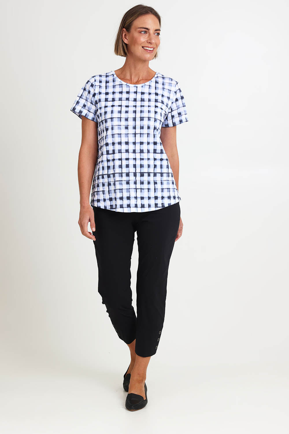 Model Riinar wearing size 10 of the Here Comes Summer Tee – Checkers in colour Checkers, from the front