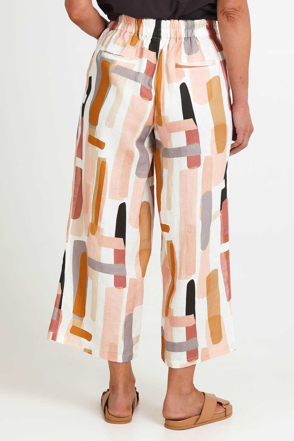 Model Riinar wearing size 10 of the Its Only Natural Pant – Blockart in colour Blockart, from an angle