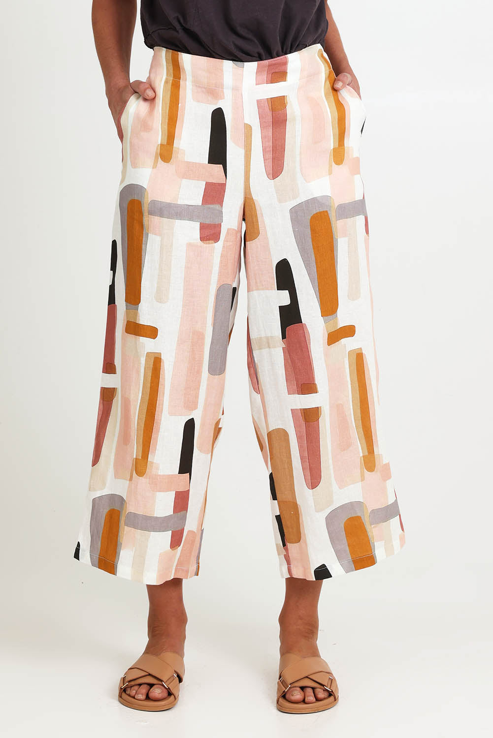 Model Riinar wearing size 10 of the Its Only Natural Pant – Blockart in colour Blockart, in a cropped view