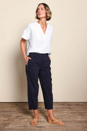 Model Riinar wearing size 10 of the Pump It Up Pant – Navy in colour Navy, from the front