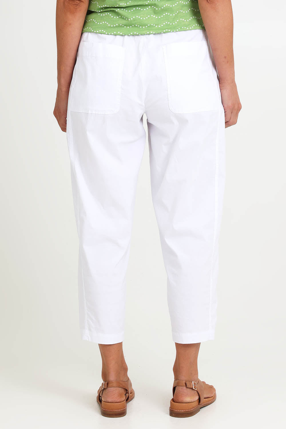 Model Riinar wearing size 10 of the Pump It Up Pant – White in colour White, from the front