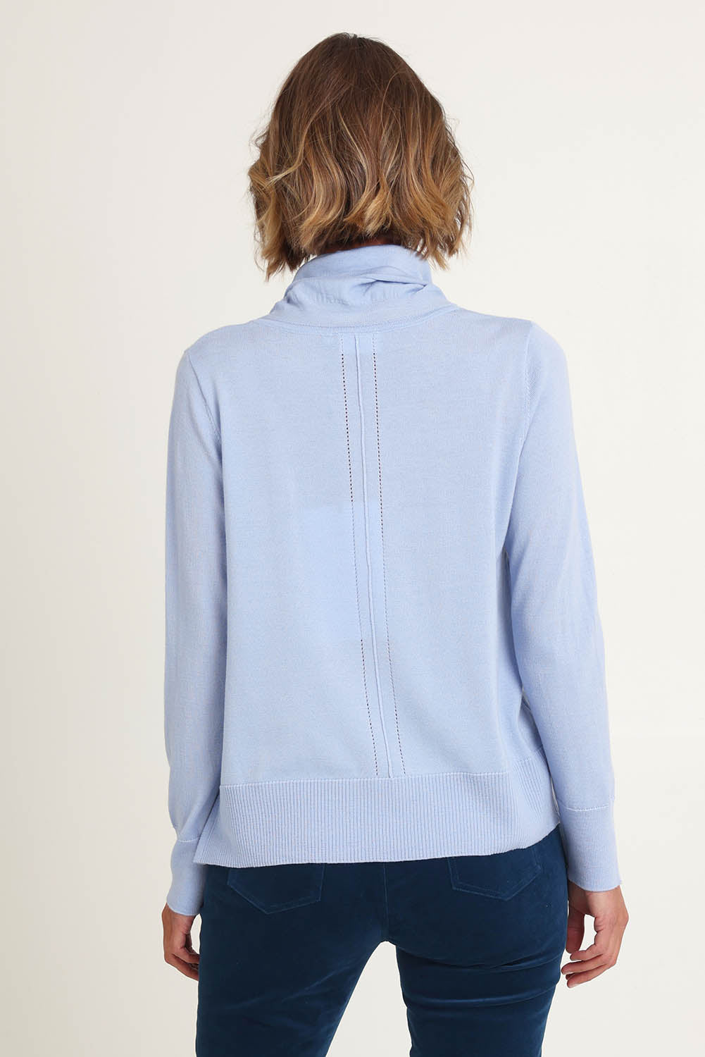 Model Riina wearing size S of the Detail Driven Sweater in colour Articblue (Blue), from the back