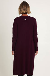 Model Riina wearing size S of the Luxe Line Cardi in colour Cherry (Purple), from the back