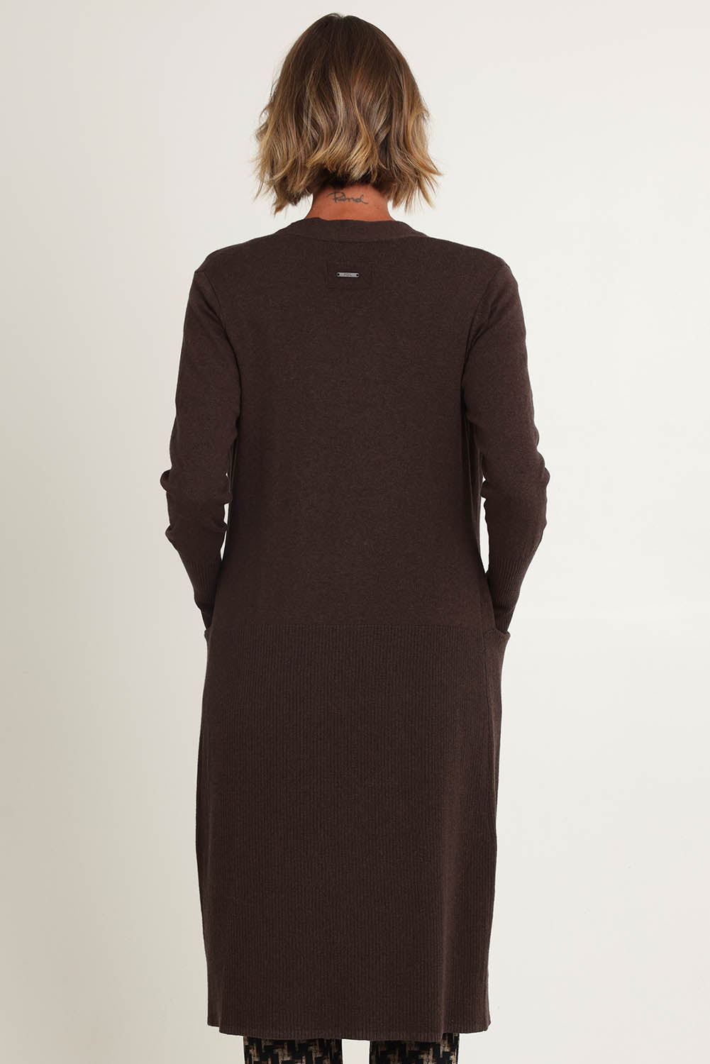 Model Riina wearing size S of the Luxe Line Cardi in colour Cocoa, from the back