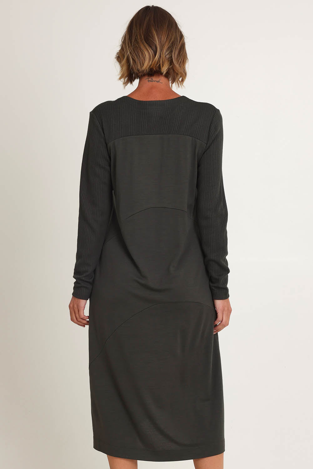 Model Riina wearing size S of the Upper Cut Dress in colour Olive (Green), from the back