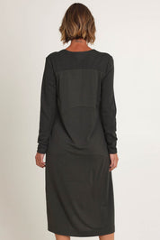 Model Riina wearing size S of the Upper Cut Dress in colour Olive (Green), from the back