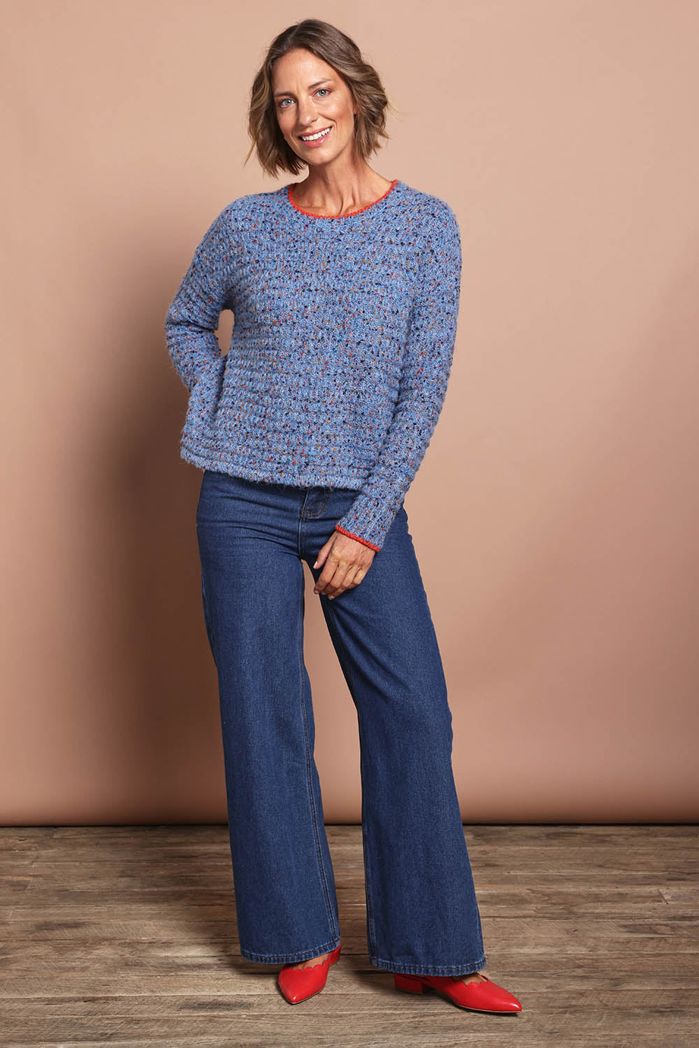 Model Riina wearing size S of the Tip Of Greatness Sweater in colour Blueaura (Blue), from the front, showing the whole outfit
