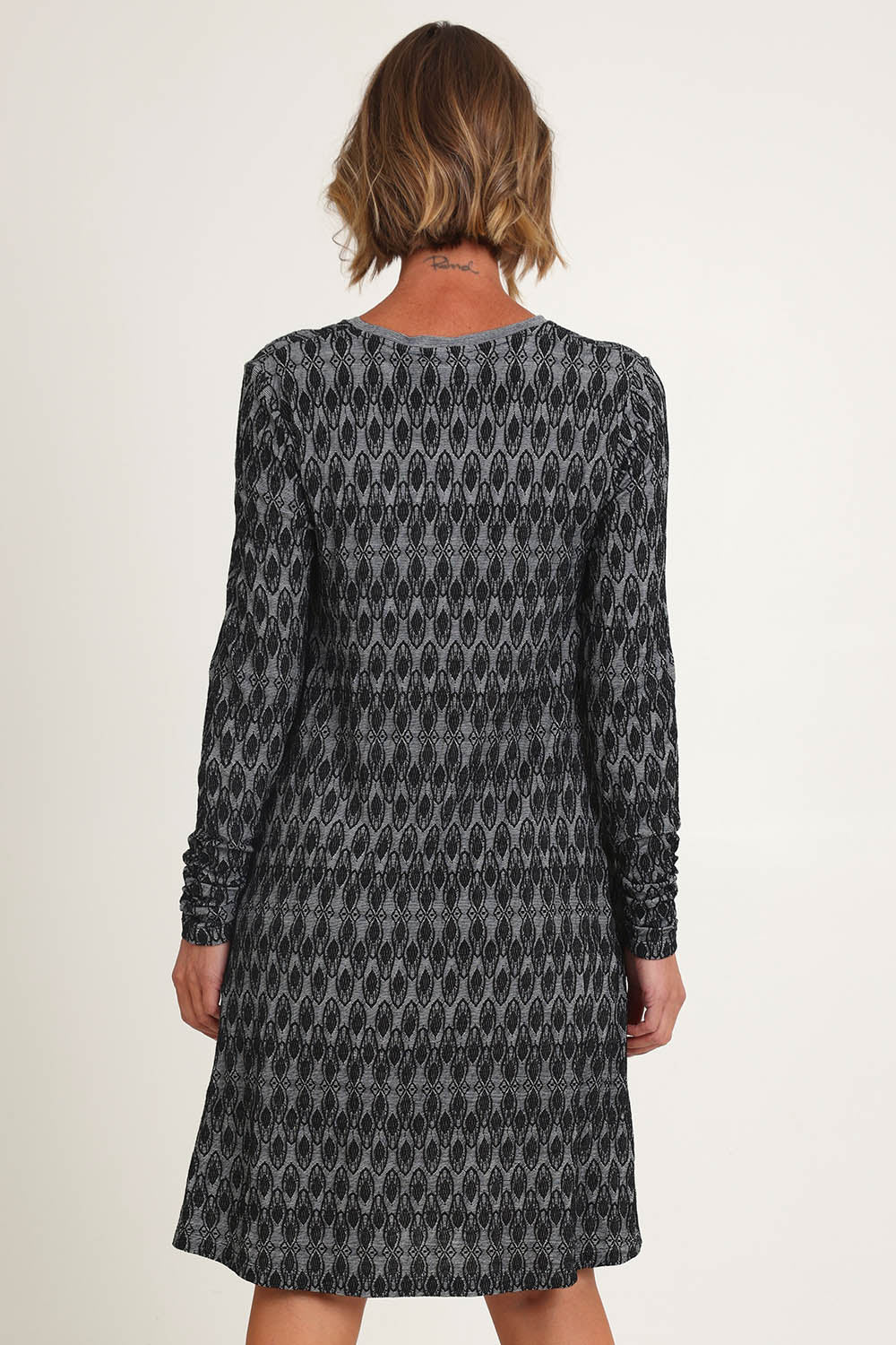 Model Riina wearing size S of the Loominary Dress in colour Black (Black), from the back
