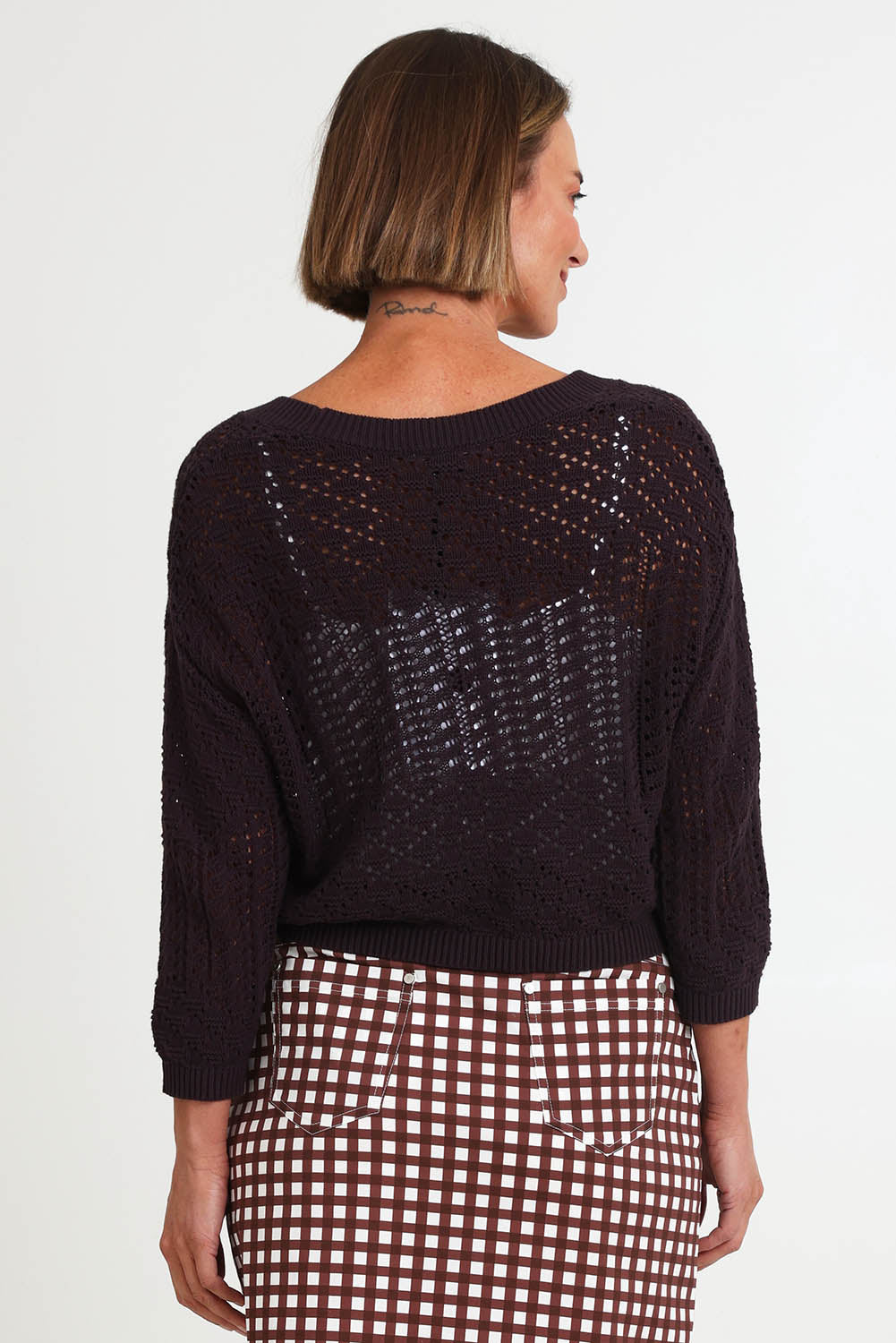 Model Riinar wearing size 10 of the Hooked On You Cardigan – Sable in colour Sable, from the back