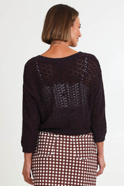 Model Riinar wearing size 10 of the Hooked On You Cardigan – Sable in colour Sable, from the back