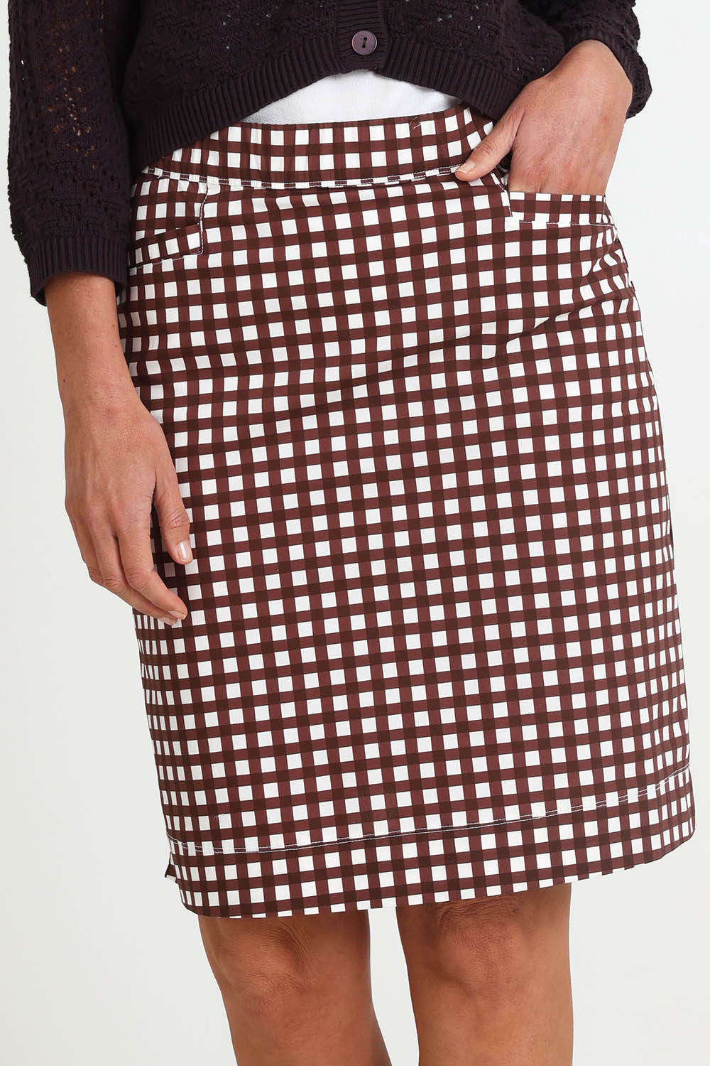 Model Riinar wearing size 10 of the Tee Riffic Skirt – Checkit in colour Checkit, from an angle
