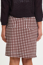 Model Riinar wearing size 10 of the Tee Riffic Skirt – Checkit in colour Checkit, from the back