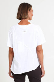 Model Riinar wearing size 10 of the Spliced And Diced Tee – White in colour White, from the back