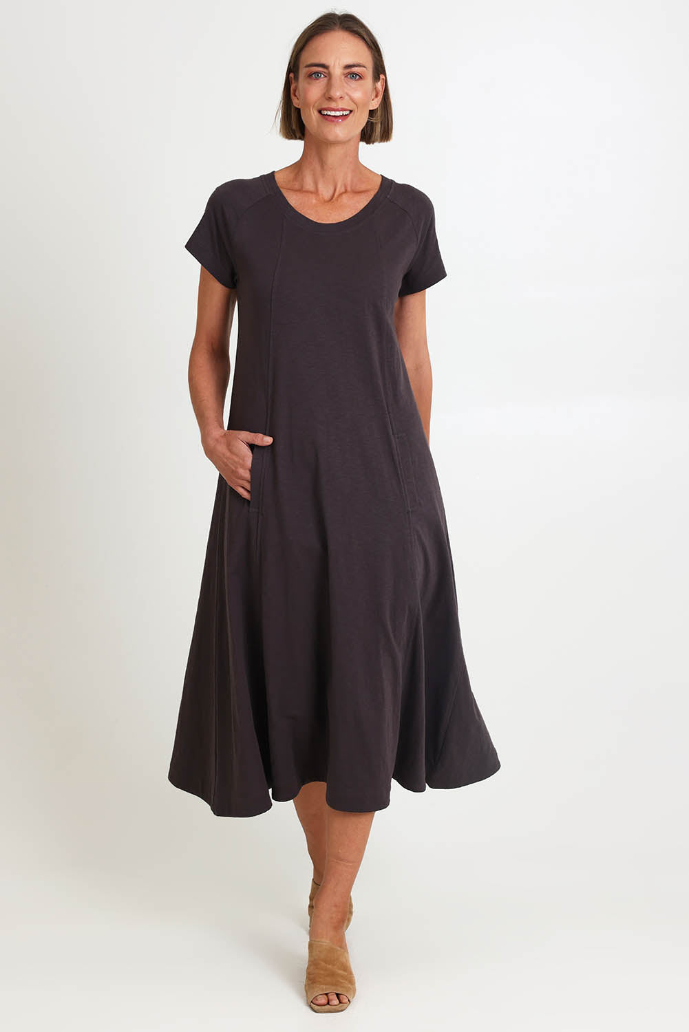 Model Riinar wearing size 10 of the Seamingly Good Dress – Sable in colour Sable, from the front