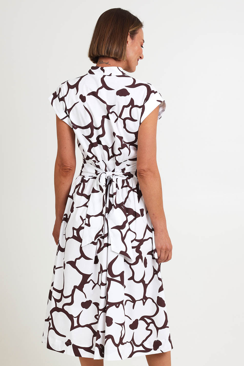 Model Riinar wearing size 10 of the Gifted Dress – Upsadaisy in colour Upsadaisy, from an angle