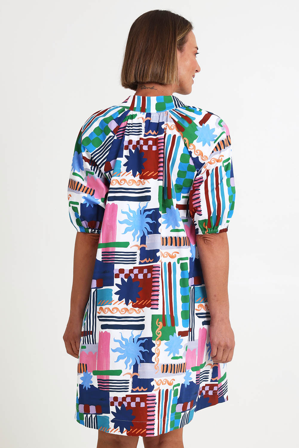 Model Riinar wearing size 10 of the Up And Coming Dress – Delsol in colour Delsol, from the back