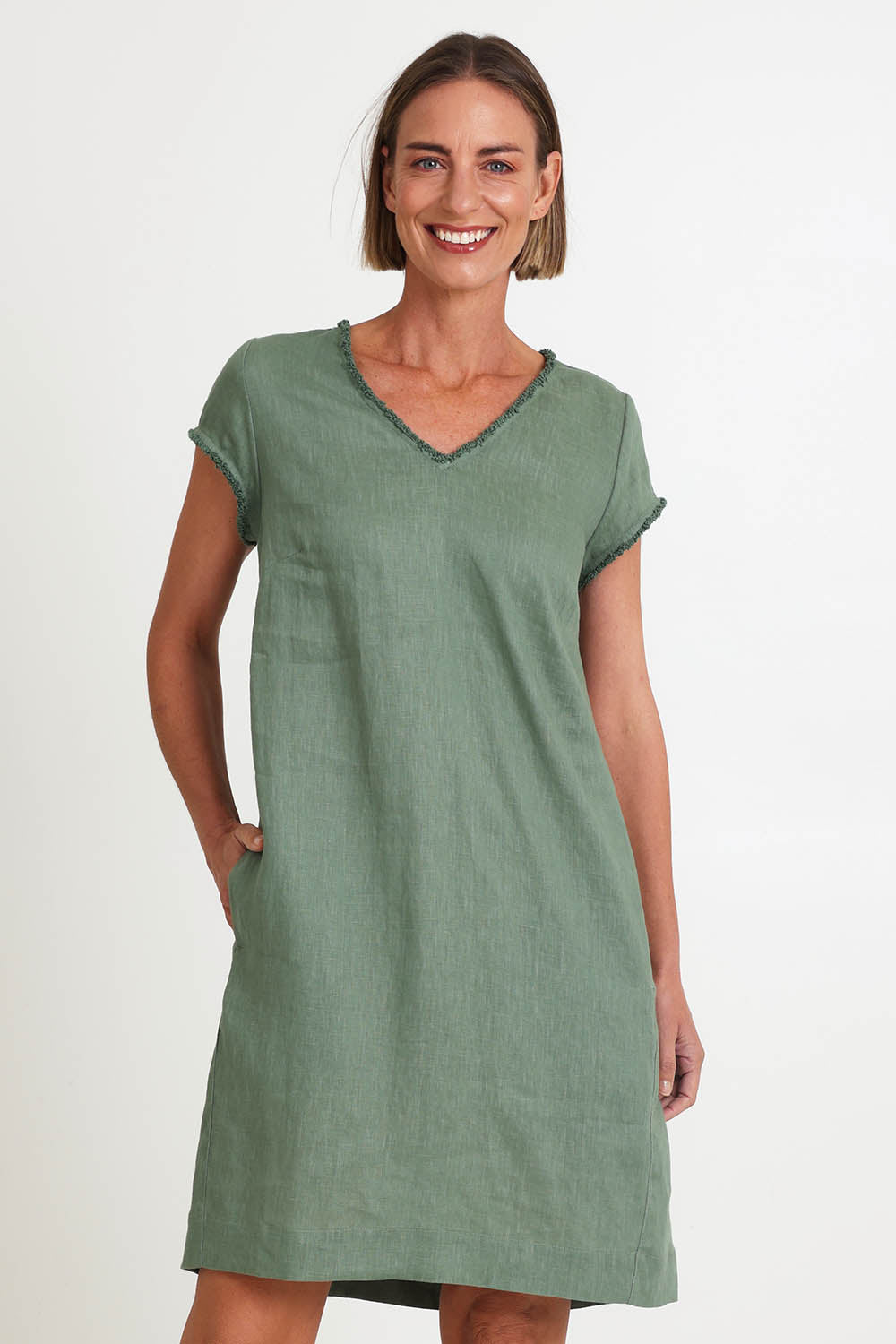 Model Riinar wearing size 10 of the V Festival Dress – Sage in colour Sage, in a cropped view