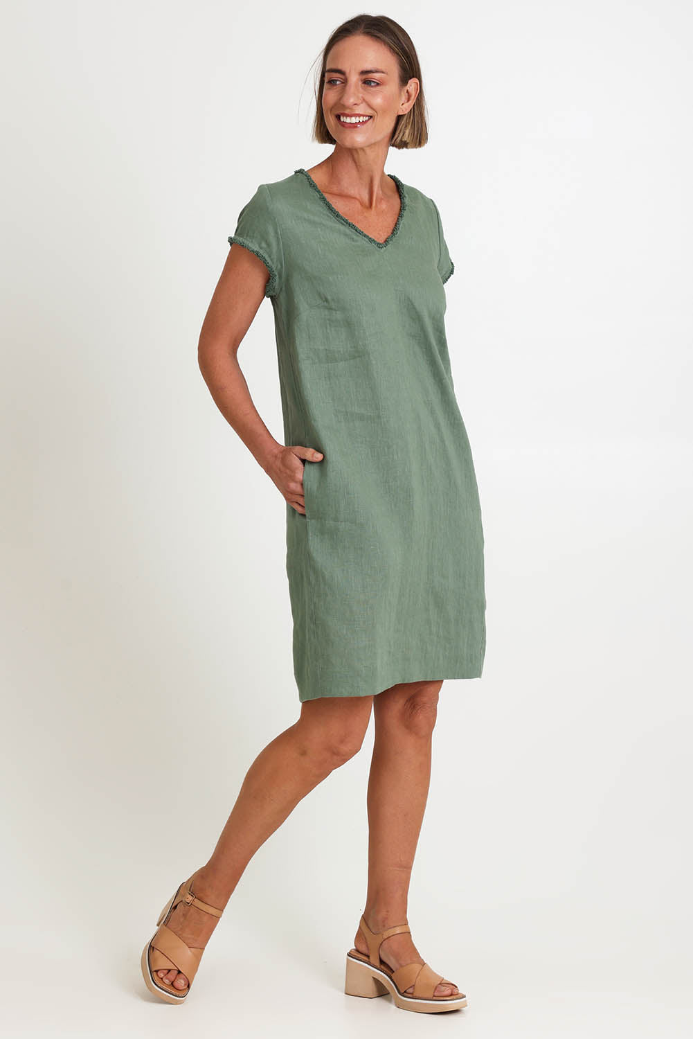 Model Riinar wearing size 10 of the V Festival Dress – Sage in colour Sage, from the front