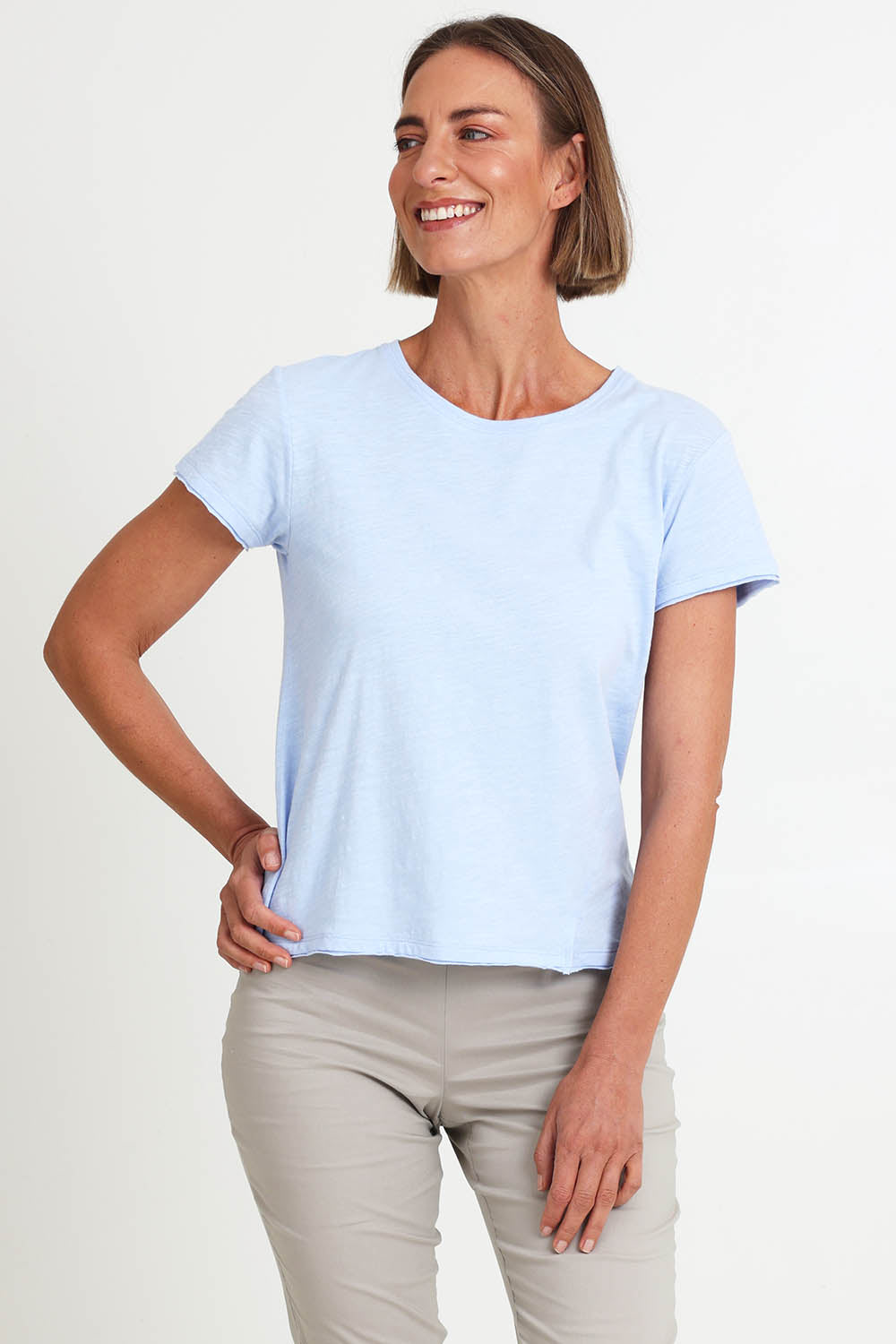 Model Riinar wearing size 10 of the Intersection Tee – Sky in colour Sky, from the front