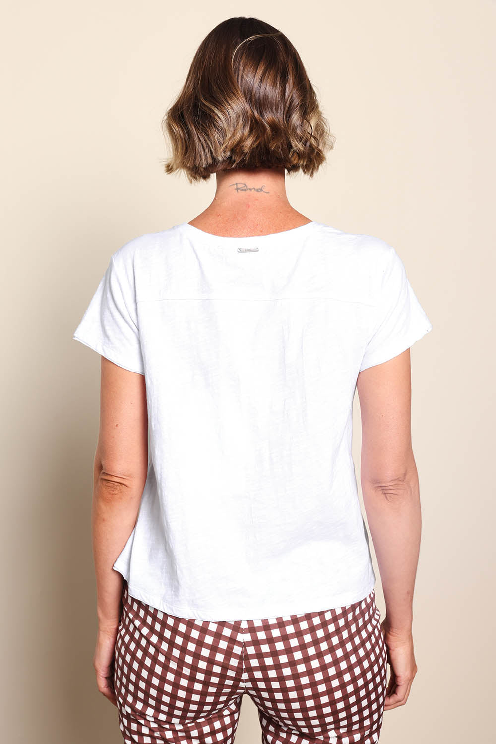 Model Riinar wearing size 10 of the Intersection Tee – White in colour White, from the back