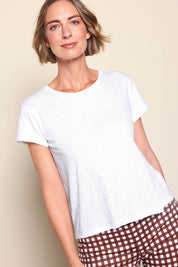 Model Riinar wearing size 10 of the Intersection Tee – White in colour White, in a cropped view
