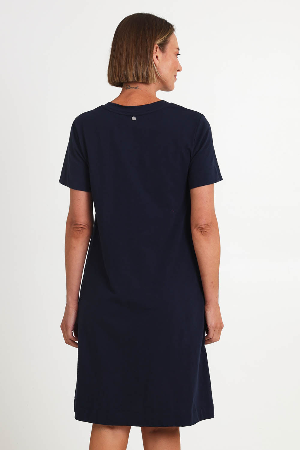 Model Riinar wearing size 10 of the Bright Spot Dress – Truenavy in colour Truenavy, from the back