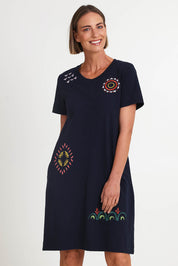 Model Riinar wearing size 10 of the Bright Spot Dress – Truenavy in colour Truenavy, in a cropped view