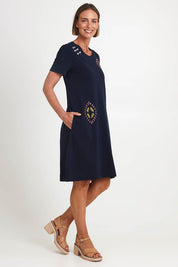 Model Riinar wearing size 10 of the Bright Spot Dress – Truenavy in colour Truenavy, from the front