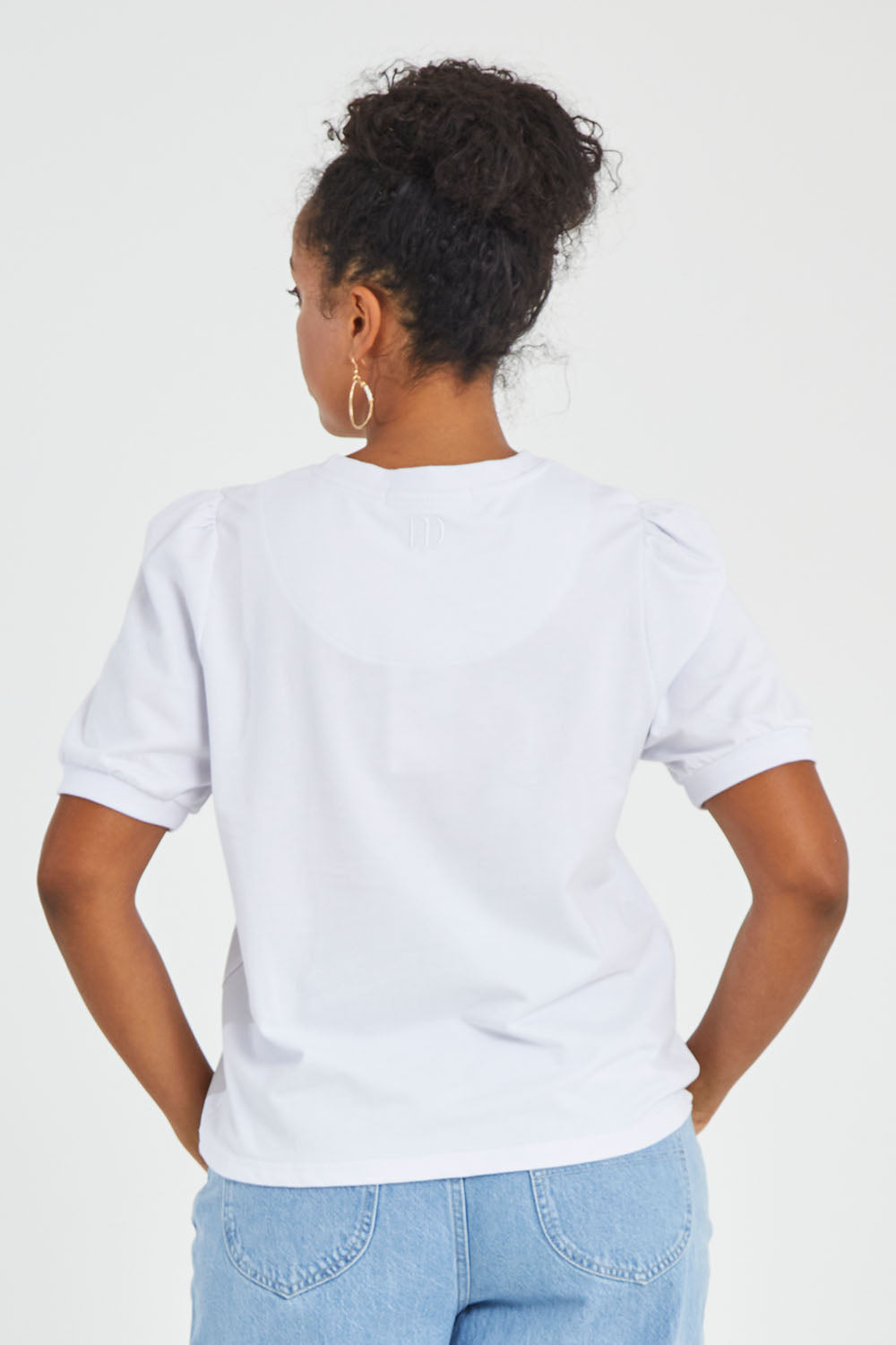 Model Noli wearing size 14 of the Ingrid Tee in colour White (White), from the back