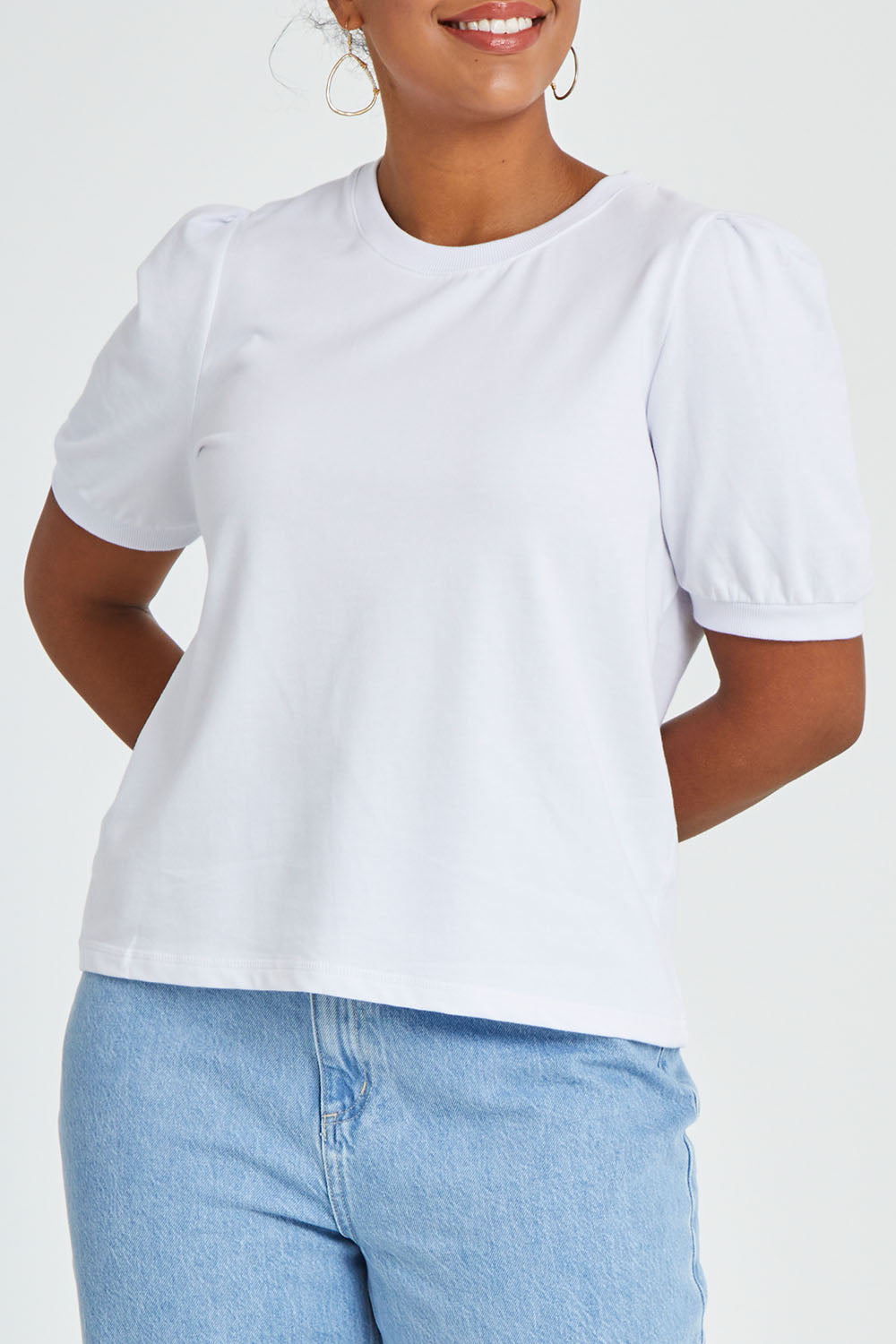 Model Noli wearing size 14 of the Ingrid Tee in colour White (White), from the front, cropped image