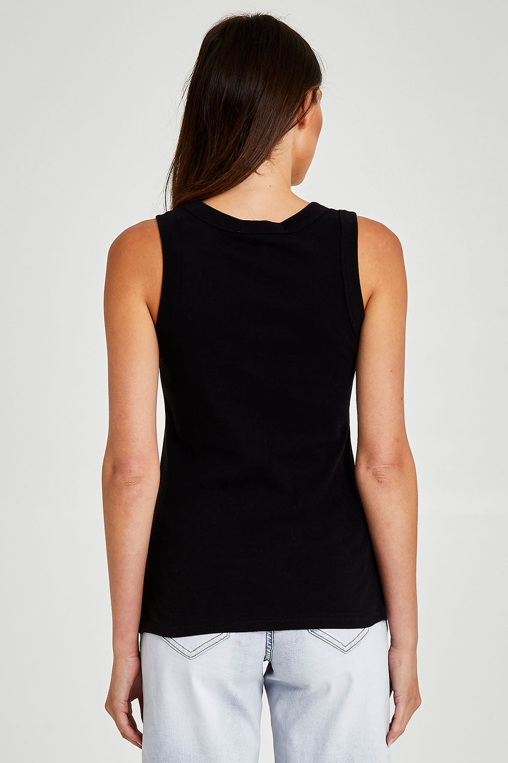 Model Madeline wearing size 10 of the Esme Cotton Tank in colour Black (Black), from the back