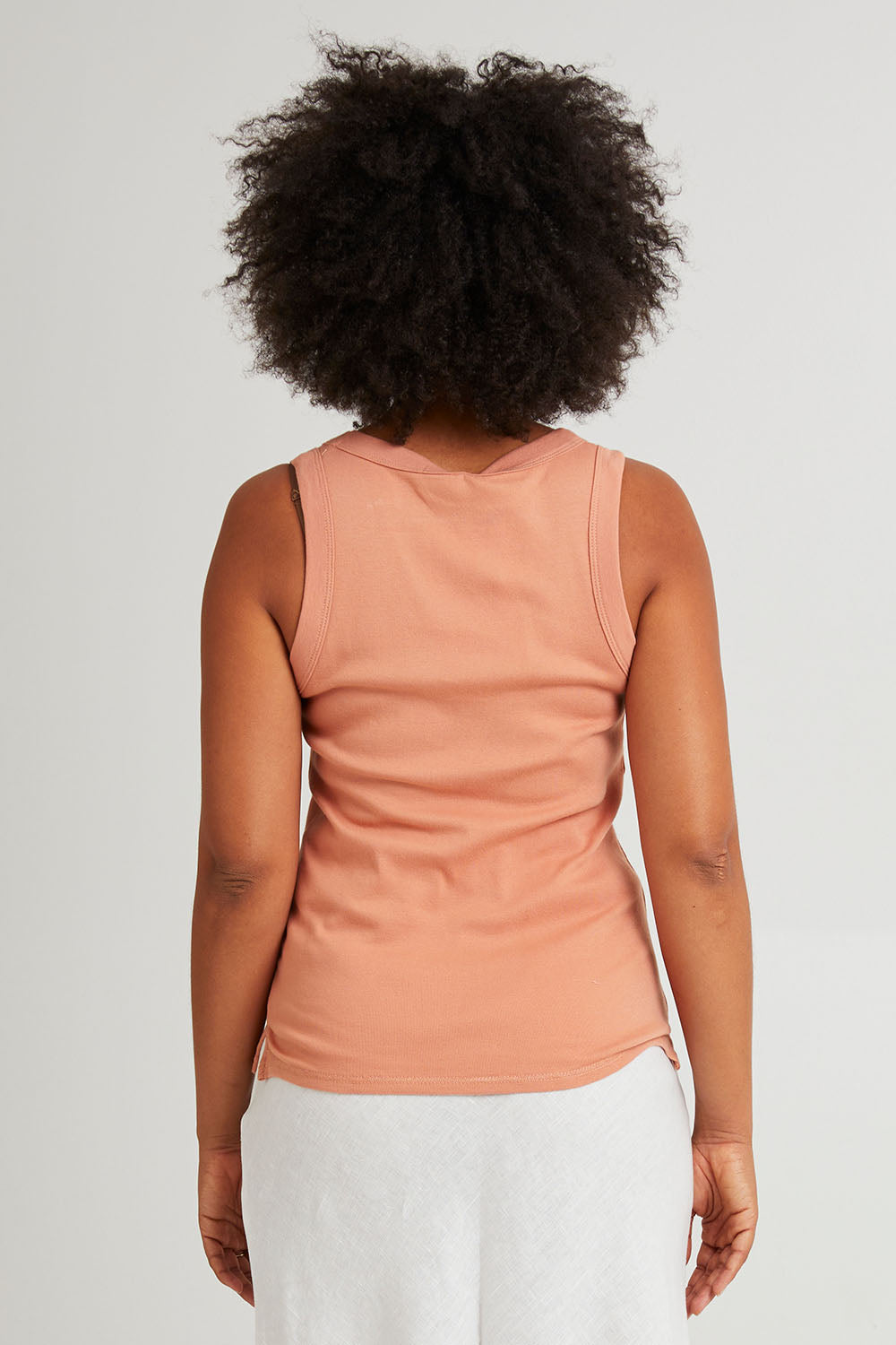 Model Olivia wearing size 10 of the Esme Cotton Tank in colour Clay, from the back