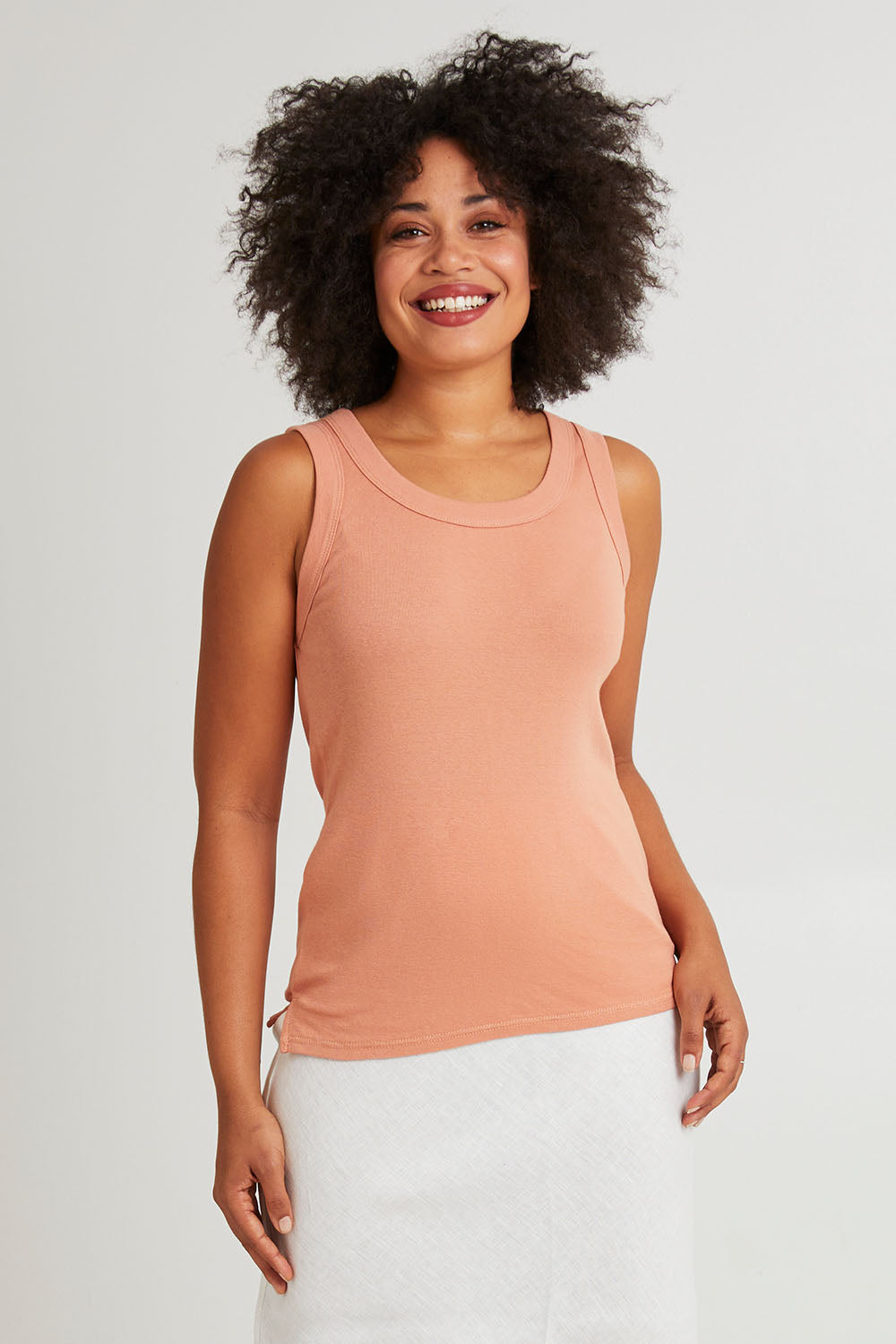 Model Olivia wearing size 10 of the Esme Cotton Tank in colour Clay, from the front, cropped image