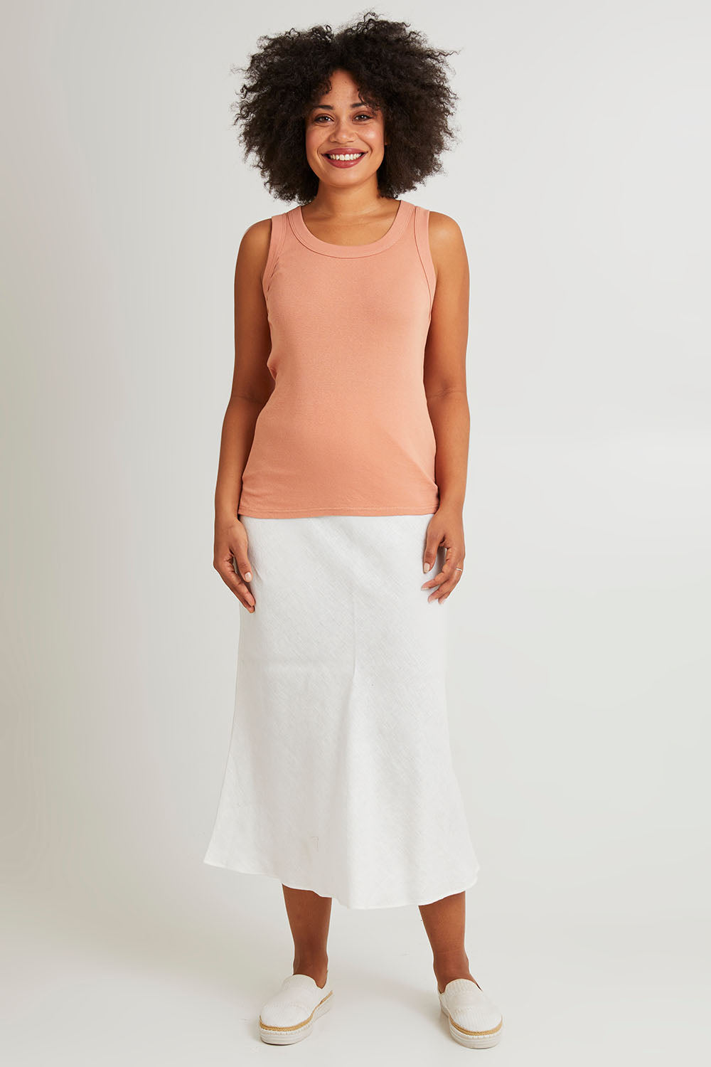 Model Olivia wearing size 10 of the Esme Cotton Tank in colour Clay, from the front, showing the whole outfit
