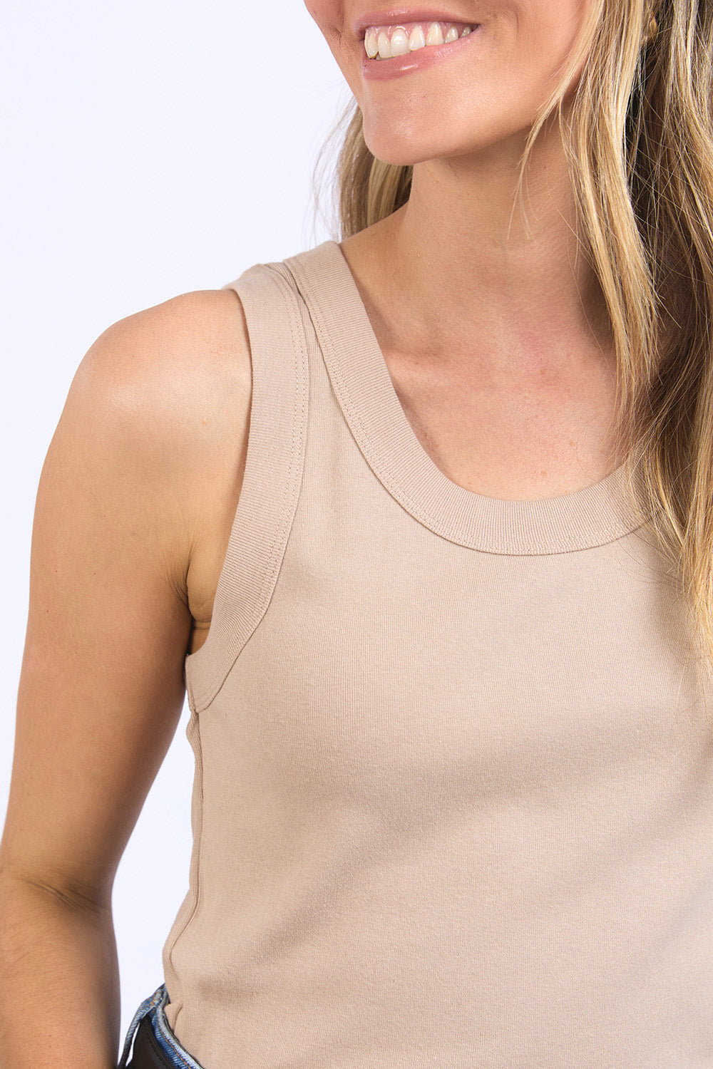 A model wearing the Esme Cotton Tank in colour Oatmeal, from the front, cropped image