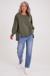 Model Luisa wearing size 10 of the Oversized Crew in colour Khaki (Green), from the front, showing the whole outfit