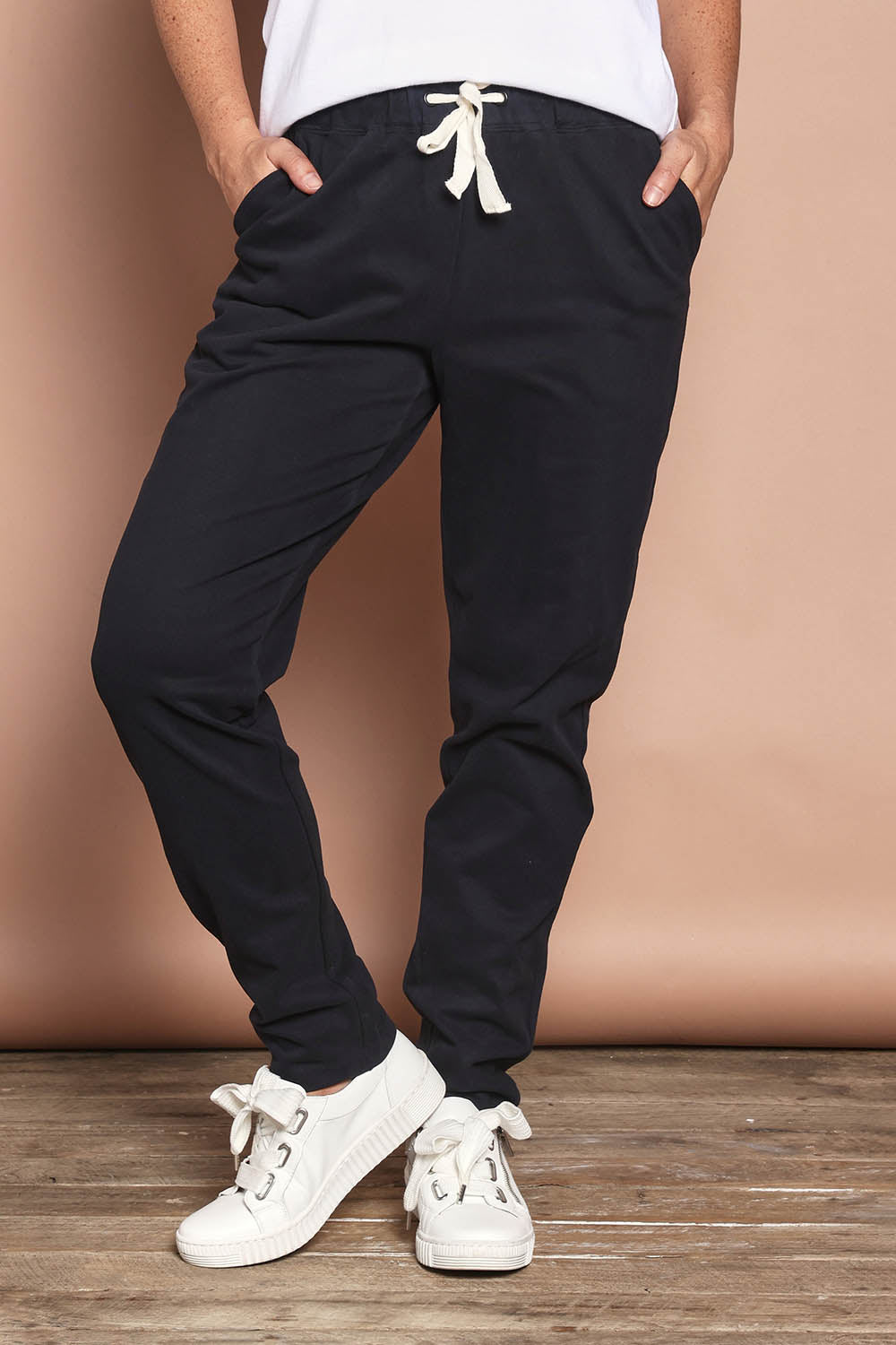 Model Katie wearing size 8 of the Elements Monday Cotton Pant in colour Black (Black), from the front, cropped image