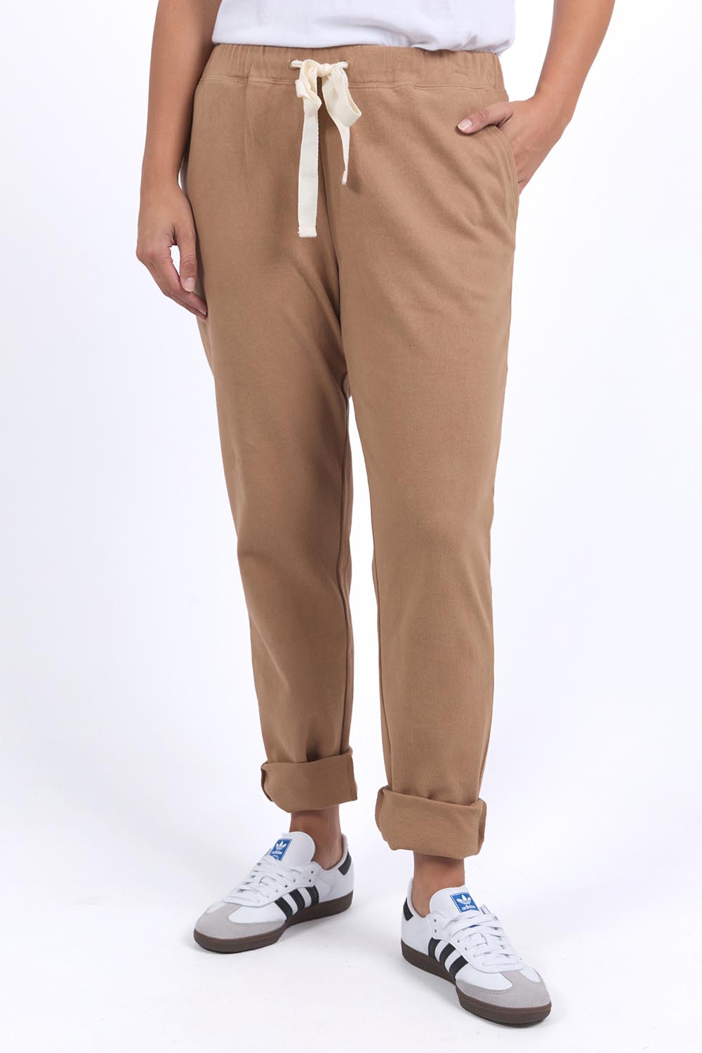 A model wearing the Elements Monday Cotton Pant in colour Coconut, from the front, cropped image