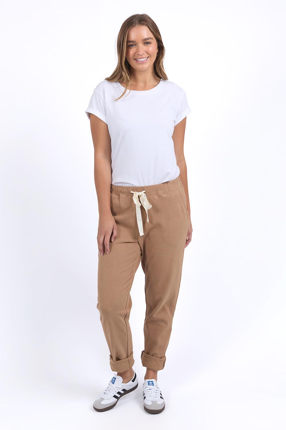 A model wearing the Elements Monday Cotton Pant in colour Coconut, from the front, showing the whole outfit