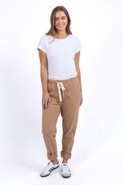 A model wearing the Elements Monday Cotton Pant in colour Coconut, from the front, showing the whole outfit
